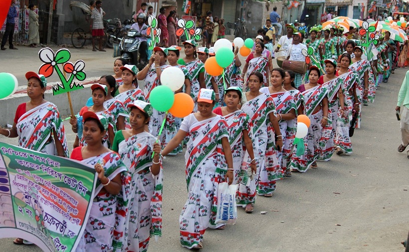 Balurghat: Trinamool Congress workers participate in an election rally inBalurghat of West Bengal's South Dinajpur district on April 15, 2016. (Photo: IANS)