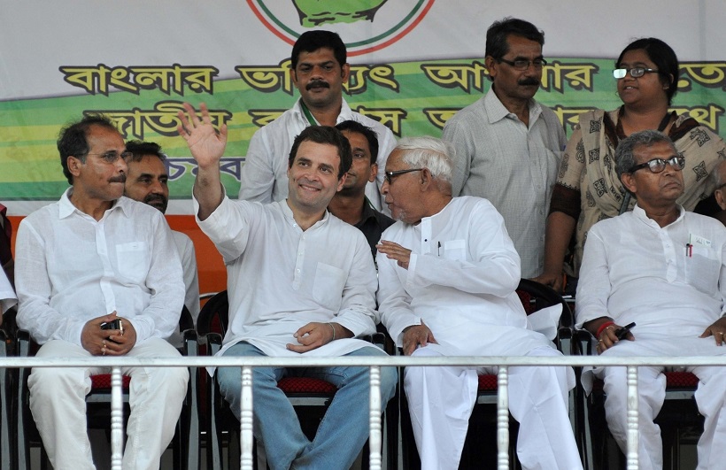 Kolkata: Congress vice president Rahul Gandhi, West Bengal Congress chief Adhir Ranjan Chowdhury and CPI-M leader Buddhadeb Bhattacharya during a Congress-Left alliance rally in Kolkata on April 27, 2016. (Photo: Kuntal Chakrabarty/IANS)
