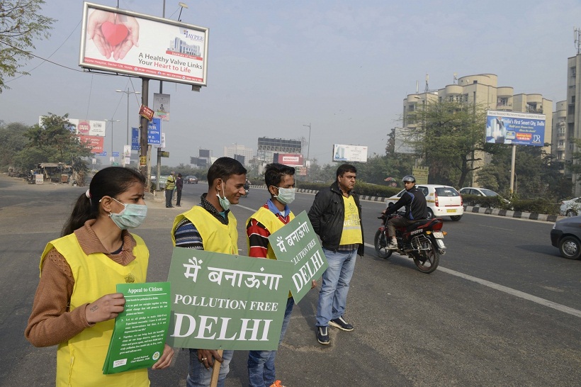 New Delhi: Civil defence volunteers stand on Delhi roads holding placards on the Day-5 of implementation of state government`s odd even formula in the national capital on Jan 5, 2016.  (Photo: IANS)